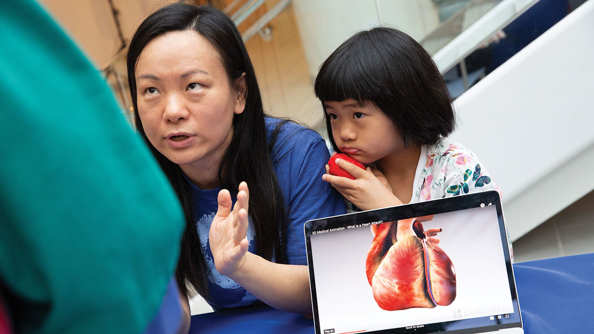 Mother and daughter listening to Dr discuss the human heart