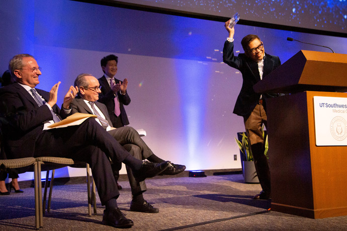 Man on stage receiving an award