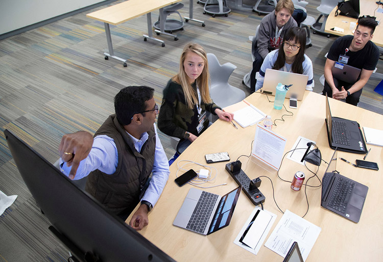 Team sitting in front of screen, discussing something