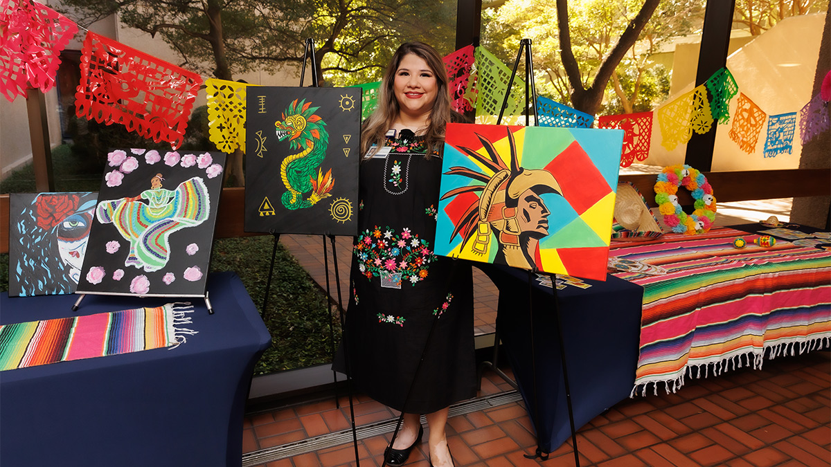 woman holding colorful paintings