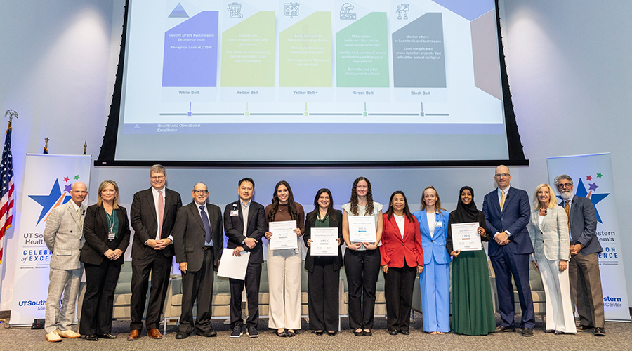 leaders and speakers stand on stage with APEX award winners- group of 14 diverse people