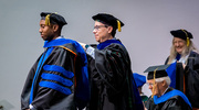 Biological Chemistry graduate Joshua Robinson, Ph.D., is hooded by Daniel Siegwart, Ph.D., Professor of Biomedical Engineering, Biochemistry, and in the Harold C. Simmons Comprehensive Cancer Center.