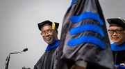 Ian Corbin, Ph.D., Associate Professor in the Advanced Imaging Research Center and of Internal Medicine and Radiology, left, and Steve Jiang, Ph.D., Vice Chair of Digital Health & AI, Chief of the Division of Medical Physics and Engineering, and Professor of Radiation Oncology, look on with pride as graduates cross the stage.