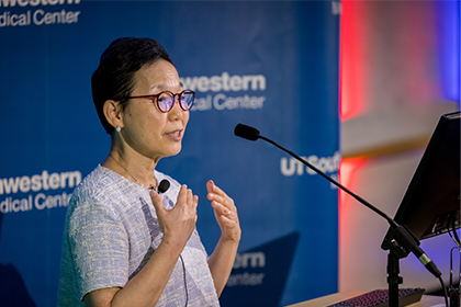 Woman speaks from UTSW podium.