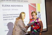 Janelle Browne presents Dr. Elena Nosyreva a certificate for her artwork in the color photography division.