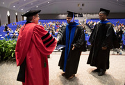 Dr. Souparno Bhattacharya receives his diploma from President Dr. Daniel K. Podolsky after being hooded by his mentor, Dr. Asaithamby Aroumougame.