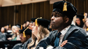 Doctor of Physical Therapy graduate Sylva Uwimana listens intently to commencement instructions.