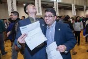 Tri Pham (left) and Devin Shah are all smiles opening their letters.