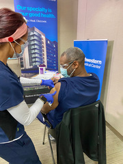 Vaccinations were administered over 16-hour shifts through a tiered distribution that prioritized protection for employees who care directly for COVID-19 patients or work in proximity to them.