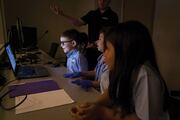 Jack Berry, center, is excited to learn about the control room that makes simulation rooms come to life.