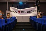 Dr. Becky Ennis’ NICU team surprises her with a large sign of support that they proudly displayed during her acceptance speech.