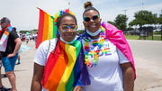 Parade: At the parade, UTSW employee Erica Ashley Cox (left) poses for a photo with spouse Nay Cox.