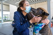 A health care staff member gets a kiss from Rusty.
