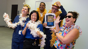 UT Southwestern’s PACT Program celebrated exceptional customer service by employees in a series of get-togethers that included an ice cream social, photo opportunities, and a pin presentation. Above, attendees at one of the summer ice cream socials for Gold pin recipients take advantage of the party props.