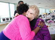 Employee Recognition Committee Chair Shirley Zwinggi hugs honoree Gwen Griffin.