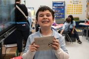 This young learner is all smiles showing off his finished valentine.