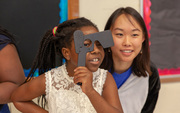 Third grader Vhinu Womeni (left) takes a closer look, along with first-year medical student Angela Zhang.