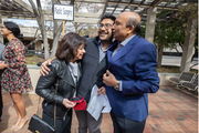 Ahneesh Mohanty (center) and his parents share a family hug after his match reveal.