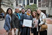 Physician Assistant Studies graduate Jared Reyna takes a group photo with family and friends.
