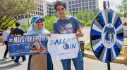 Yasmeen Khan (left) and Michael Jimenez showing off their prizes after spinning the wheel.