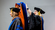 Clinical Psychology graduate Hudaisa Fatima, Ph.D., is hooded by Laura Lacritz, Ph.D., Chief of the Division of Psychology and Professor of Psychiatry and Neurology.