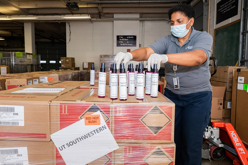 Woman in mask sorting spray bottles