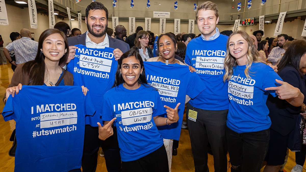 Six smiling students hold up blue t-shirts with their match information printed on it. Copy - I Matched into Internal Medicine at UTMB #utswmatch, I Matched into Med-Peds at UTSW #utswmatch, I Matched into OB/GYN at UW #utswmatch, I Matched into Internal Medicine at Jefferson #utswmatch, I Matched into Pediatrics at Phoenix Children's #utswmatch, and I Matched into Psychiatry at Jackson - MS #utswmatch