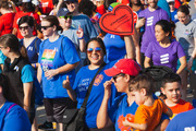 With her UTSW heart in hand, this walker gives a big thumbs up to the camera while keeping a strong stride in the crowd.