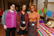 Three employees enjoy the reception festivities.