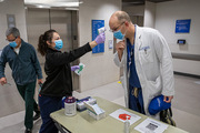 In April, temperature screenings became required for employees and visitors at UTSW’s hospital, clinics, and buildings amid the pandemic. Screener Dora Irma Garcia checks Dr. Seth Toomay as he enters West Campus Building 3.