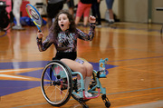 An excited participant celebrates a wheelchair tennis victory.