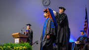 Carlos Paz is hooded by James Collins, Ph.D., Associate Professor of Pharmacology.