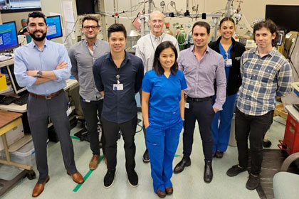 Group of people in a room surrounded by medical equipment