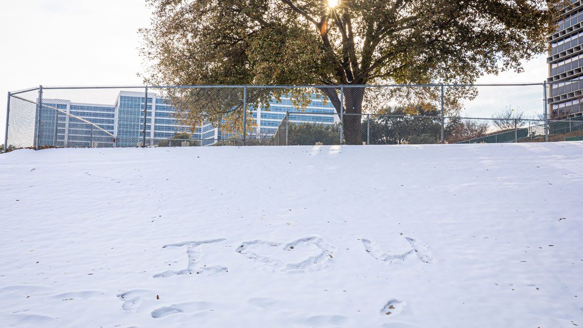 Field of snow with I heart-symbol U written in it.