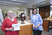 Connie Roberts (left), and Courtney Crothers pose with Ms. Roberts’ Santa, which earned honorable mention in the Mixed Media category.