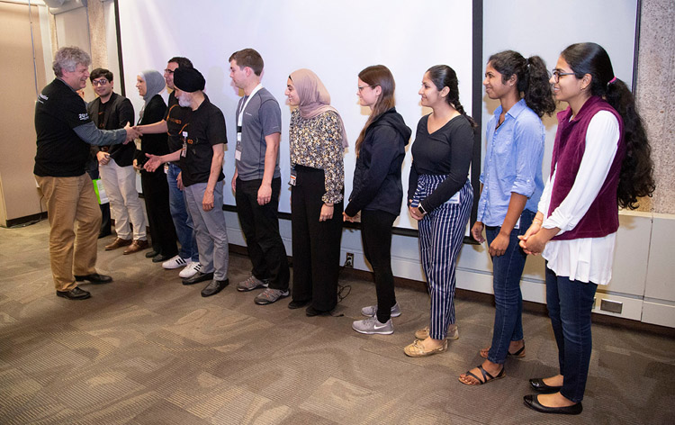 Man shaking hands with a line of people