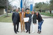 Physician Assistant Studies graduate Corey Senegal poses for a photo with family and friends.