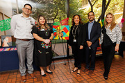 From left: BRG members Erasmo Salima, Ms. Hargrove, Ms. Bell, Nicolas Carmona, and Ms. Ramos pose with art during the reception.