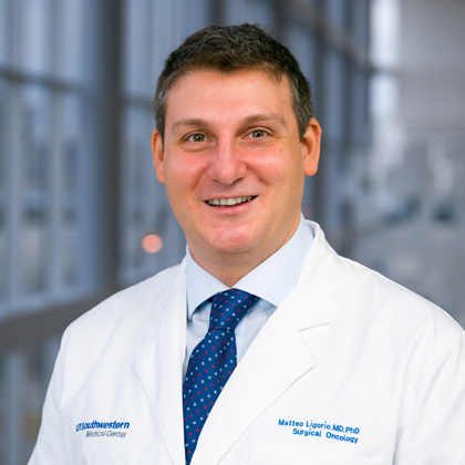 Man in white lab coat, blue tie