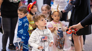 This young astronaut holds out his bag for a treat.