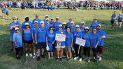 A team of walkers called Team BrAve Hearts, led by Holly Crawford, M.B.A., UTSW Executive Vice President for Business Affairs, poses for a group shot before the walk.
