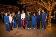 Dr. Becky Ennis, winner of a Patient and Family Recognition Award, and members of the NICU team bask in a gorgeous December night on McDermott Plaza.