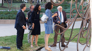 Honoree Dr. Goldstein shows speakers one of his many UTSW art donations at the event celebrating his five-decade research partnership with Dr. Brown.