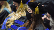Brittany Nicole Wright (left) and Chung Lin Kew wait to cross the stage to receive their Doctor of Philosophy degrees.