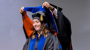 Cancer Biology graduate Nicole McCuen, Ph.D., takes in the moment as she receives her hood.