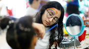 A UTSW student paints a pretty design on the face of an eager attendee at UT Southwestern’s 18th annual Carnaval de Salud on April 22. The health fair event offered numerous ways for families to learn through safe, interactive experiments. Children lined up to make fake snow, create candy “cells,” or suture a banana while adults could take advantage of free health screenings and medical information.
