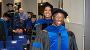 Edem Tchegnon, Ph.D., walks out of the ceremony gleaming with joy.