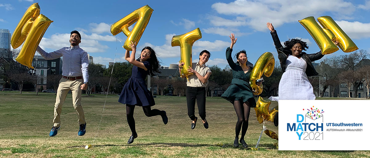 5 people holding balloon letters that spelll Match jumping