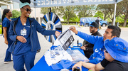 Kendra Brantley picking up her prize from the Mavs booth.