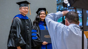 Dr. Wu poses for a photo with Genetics, Development, and Disease graduate Menaka Sanghvi, Ph.D., after she receives her diploma.